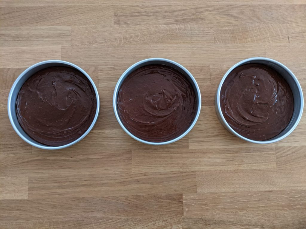 Chocolate cake mixture in pans
