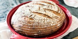 Freshly baked organic sourdough bread in a red dutch oven