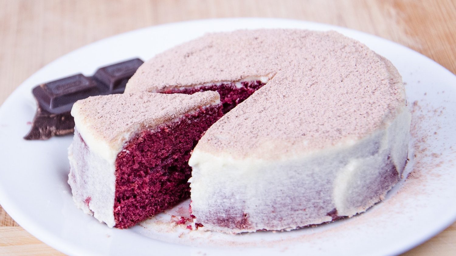 A cut slice of a single layer red velvet cake.