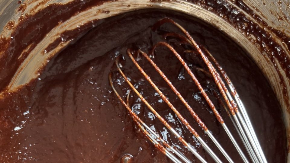 Brownie batter with a whisk.