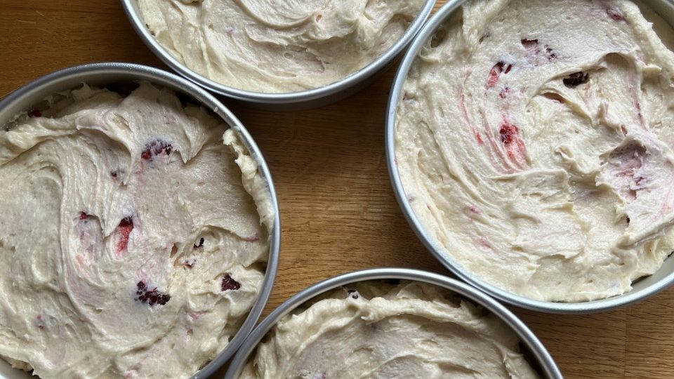 Cake tins with cake batter in before baking.